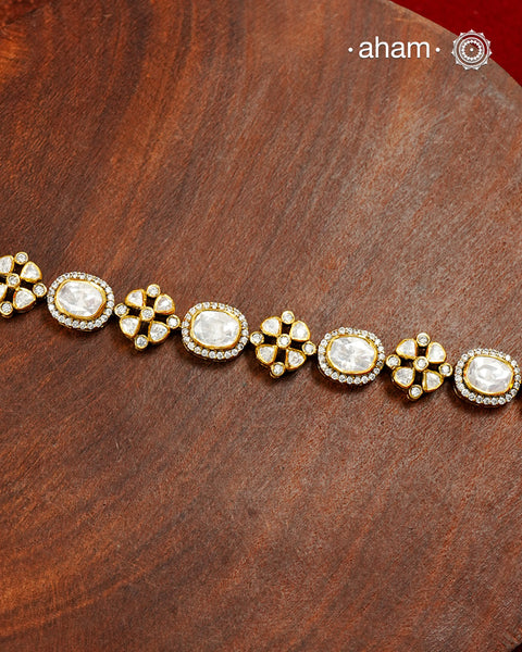 Handcrafted in 92.5 silver with a gold polish finish, this elegant tennis bracelet features dazzling moissanite stones and floral motifs. A timeless statement piece designed to elevate festive, wedding, and occasion wear.
The price is for one piece only.