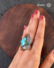 Handcrafted 92.5 sterling silver ring with turquoise stone and coral highlights.&nbsp;