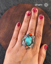 Handcrafted 92.5 sterling silver ring with turquoise stone and coral highlights.&nbsp;