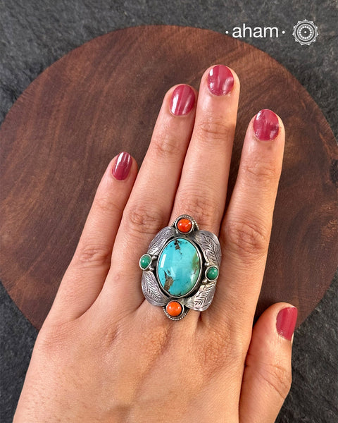 Handcrafted 92.5 sterling silver ring with turquoise stone and coral highlights.&nbsp;