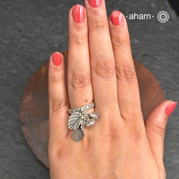 Adjustable Ring in 92.5 sterling silver with different charms.Perfect piece to add a playful tough to your look.