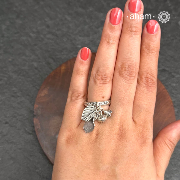 Adjustable Ring in 92.5 sterling silver with different charms.Perfect piece to add a playful tough to your look.