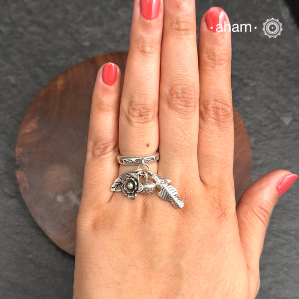 Adjustable Ring in 92.5 sterling silver with different charms.Perfect piece to add a playful tough to your look.