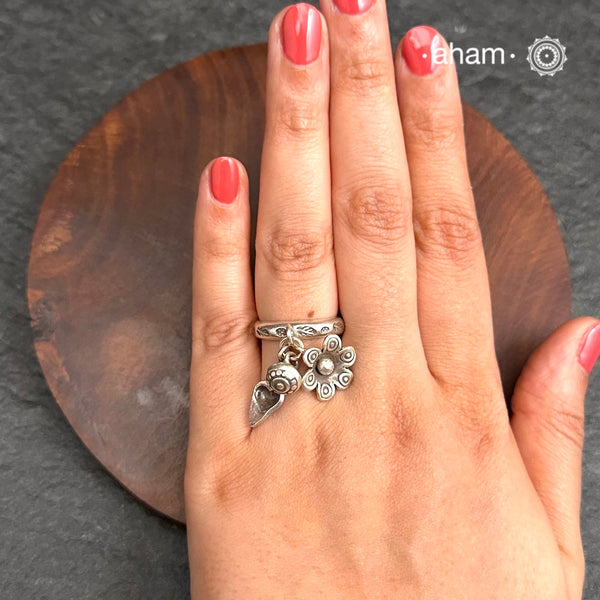 Adjustable Ring in 92.5 sterling silver with different charms.
Perfect piece to add a playful tough to your look.