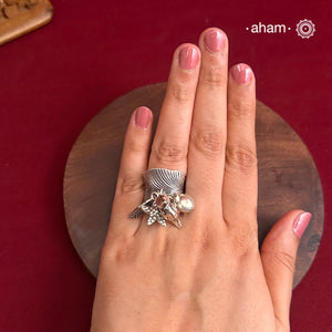 Adjustable Ring in 92.5 sterling silver with different charms.Perfect piece to add a playful tough to your look.