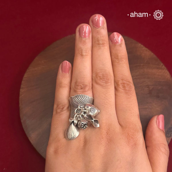 Adjustable Ring in 92.5 sterling silver with different charms.Perfect piece to add a playful tough to your look.