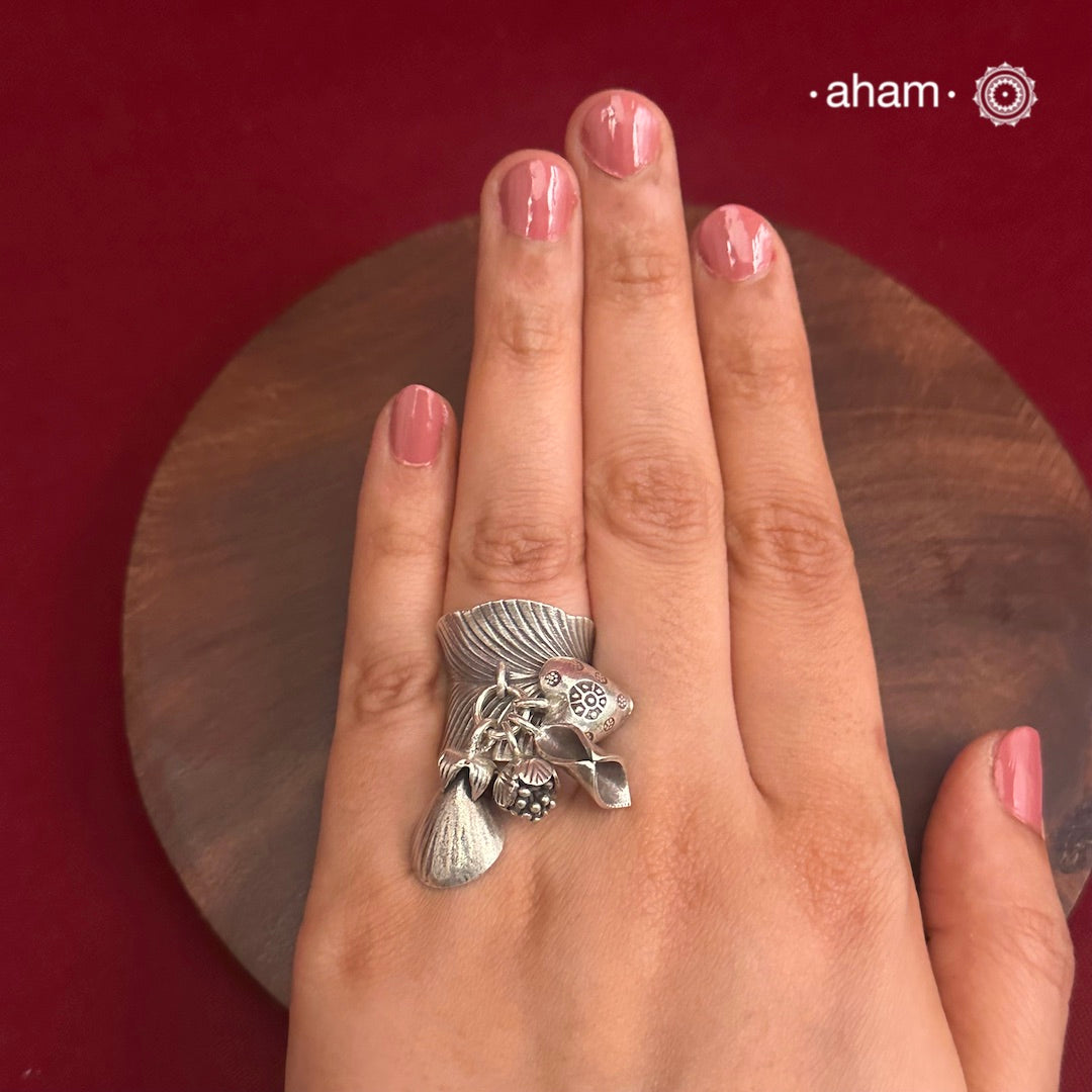 Adjustable Ring in 92.5 sterling silver with different charms.Perfect piece to add a playful tough to your look.