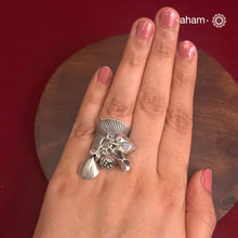 Adjustable Ring in 92.5 sterling silver with different charms.Perfect piece to add a playful tough to your look.