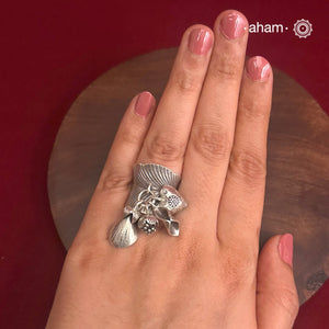 Adjustable Ring in 92.5 sterling silver with different charms.Perfect piece to add a playful tough to your look.