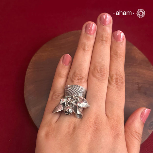 Adjustable Ring in 92.5 sterling silver with different charms.Perfect piece to add a playful tough to your look.