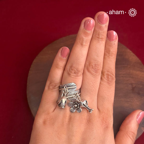 Adjustable Ring in 92.5 sterling silver with different charms.Perfect piece to add a playful tough to your look.