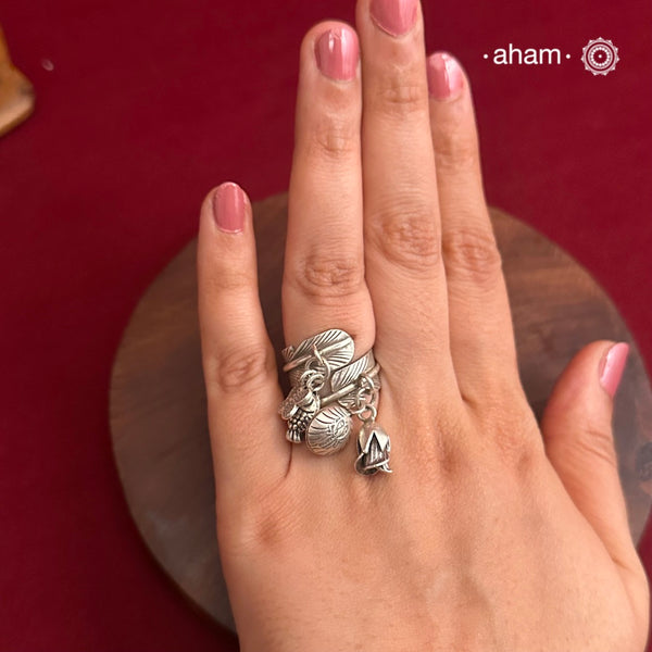 Adjustable Ring in 92.5 sterling silver with different charms.Perfect piece to add a playful tough to your look.