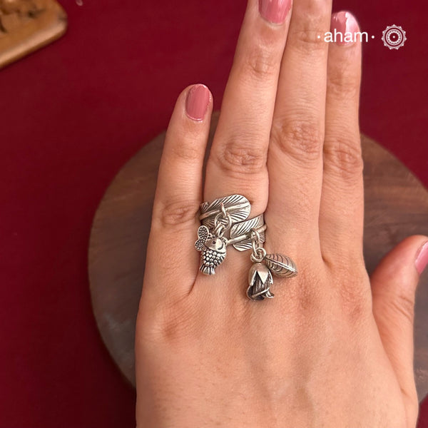 Adjustable Ring in 92.5 sterling silver with different charms.Perfect piece to add a playful tough to your look.