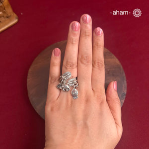 Adjustable Ring in 92.5 sterling silver with different charms.Perfect piece to add a playful tough to your look.