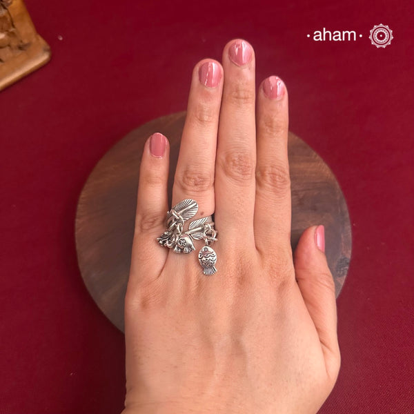 Adjustable Ring in 92.5 sterling silver with different charms.Perfect piece to add a playful tough to your look.
