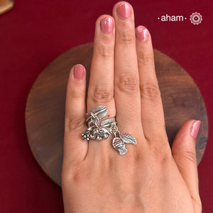 Adjustable Ring in 92.5 sterling silver with different charms.Perfect piece to add a playful tough to your look.