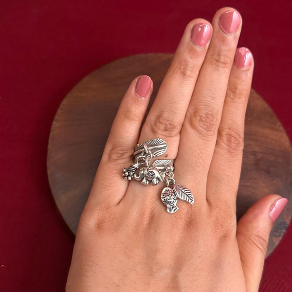 Adjustable Ring in 92.5 sterling silver with different charms.Perfect piece to add a playful tough to your look.