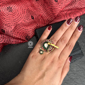 Festive gold polish adjustable ring kundan work. Handcrafted in 92.5 sterling silver with elegant floral pattern, a 3d Bird motif,  pink and green kundan work with pearl highlights. Perfect for special occasions and festivities. 