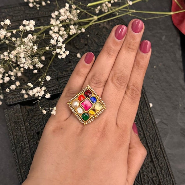 This classic Navratna ring is the perfect accessory for weddings and festive occasions. Crafted in 92.5 sterling silver and dipped in gold with a hint of pearls, it will add understated luxury to any look.