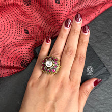 This stunning Sterling Silver Ring features a classic Victorian era style crafted with an elegant dull gold polish adorned with pink Kundan highlights. An exquisite representation of traditional design, perfect for any special occasion.