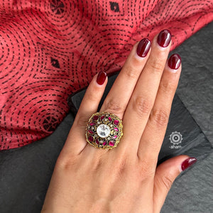 This stunning Sterling Silver Ring features a classic Victorian era style crafted with an elegant dull gold polish adorned with pink Kundan highlights. An exquisite representation of traditional design, perfect for any special occasion.