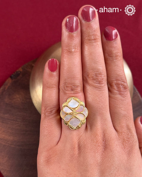 Embrace the allure of timeless elegance with Aham Jewellery’s latest Mother of Pearl collection, a radiant choice for festive celebrations and weddings.
The ring is crafted in 92.5 silver and adorned with a luxurious gold polish, capturing the iridescent beauty of mother of pearl.This collection is designed with festivities, bridesmaids, and destination weddings in mind, offering a versatile blend of tradition and contemporary charm. Ideal for those seeking an ethereal statement, our Mother of Pear
