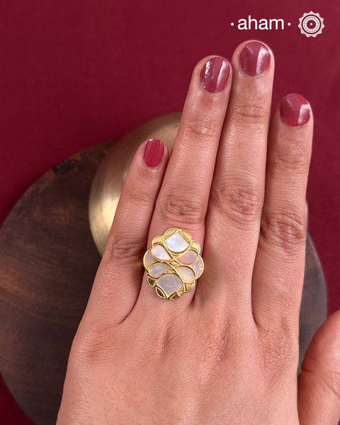 Embrace the allure of timeless elegance with Aham Jewellery’s latest Mother of Pearl collection, a radiant choice for festive celebrations and weddings.
The ring is crafted in 92.5 silver and adorned with a luxurious gold polish, capturing the iridescent beauty of mother of pearl.This collection is designed with festivities, bridesmaids, and destination weddings in mind, offering a versatile blend of tradition and contemporary charm. Ideal for those seeking an ethereal statement, our Mother of Pear