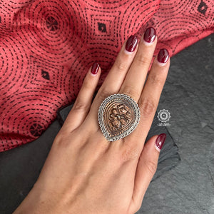 Expertly crafted, this Tribal Silver Ring boasts a beautiful Hanuman motif in copper set in a striking silver frame. The adjustable design allows for a perfect fit, making it a versatile and stylish addition to any outfit. Elevate your style with this handcrafted piece of art.