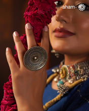 Elevate your style with the Noori Rava Work Two Tone Silver Ring. Expertly crafted with intricate rava work, this statement ring showcases a perfect balance of dull gold and silver polish. Make a bold statement and add a touch of elegance to any outfit with this beautiful accessory.