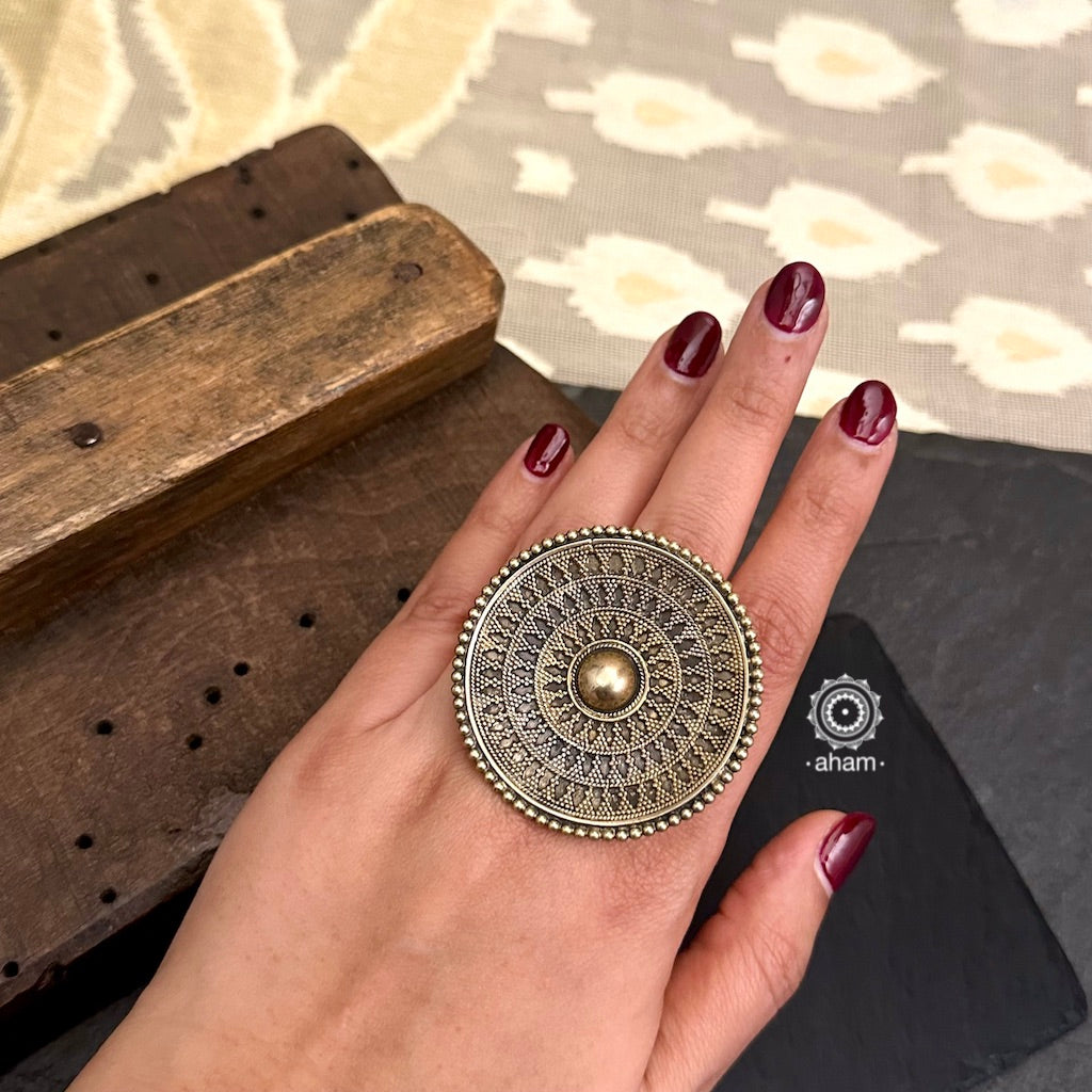 Elevate your style with the Noori Rava Work Two Tone Silver Ring. Expertly crafted with intricate rava work, this statement ring showcases a perfect balance of dull gold and silver polish. Make a bold statement and add a touch of elegance to any outfit with this beautiful accessory.
