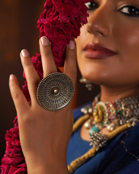 Elevate your style with the Noori Rava Work Two Tone Silver Ring. Expertly crafted with intricate rava work, this statement ring showcases a perfect balance of dull gold and silver polish. Make a bold statement and add a touch of elegance to any outfit with this beautiful accessory.