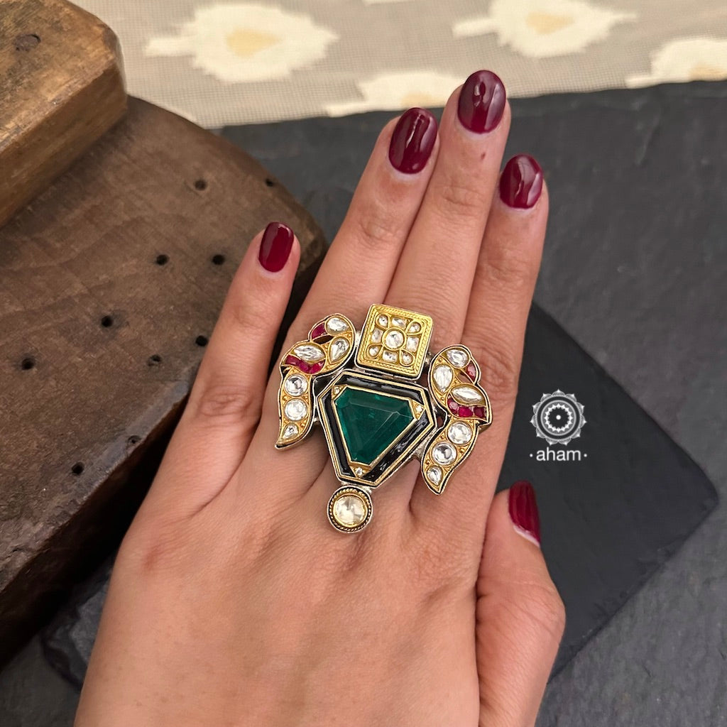 Noori two tone adjustable ring with two peacock motifs. Handcrafted in 92.5 sterling silver with green stone setting floral motif 