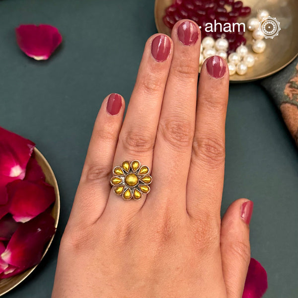 Enhance your style with the timeless elegance of the Two Tone Silver Ring. Handcrafted by skilled karigars in Barmer, Rajasthan, this ring features traditional Bandhel work, where a thin sheet of 22 carat hand beaten gold is set on silver using a unique wax filling technique. A classic representation of Indian craftsmanship.