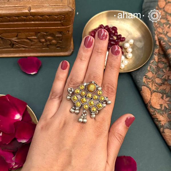 Enhance your style with the timeless elegance of the Two Tone Silver Ring. Handcrafted by skilled karigars in Barmer, Rajasthan, this ring features traditional Bandhel work, where a thin sheet of 22 carat hand beaten gold is set on silver using a unique wax filling technique. A classic representation of Indian craftsmanship.