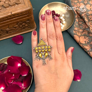 Enhance your style with the timeless elegance of the Two Tone Silver Ring. Handcrafted by skilled karigars in Barmer, Rajasthan, this ring features traditional Bandhel work, where a thin sheet of 22 carat hand beaten gold is set on silver using a unique wax filling technique. A classic representation of Indian craftsmanship.