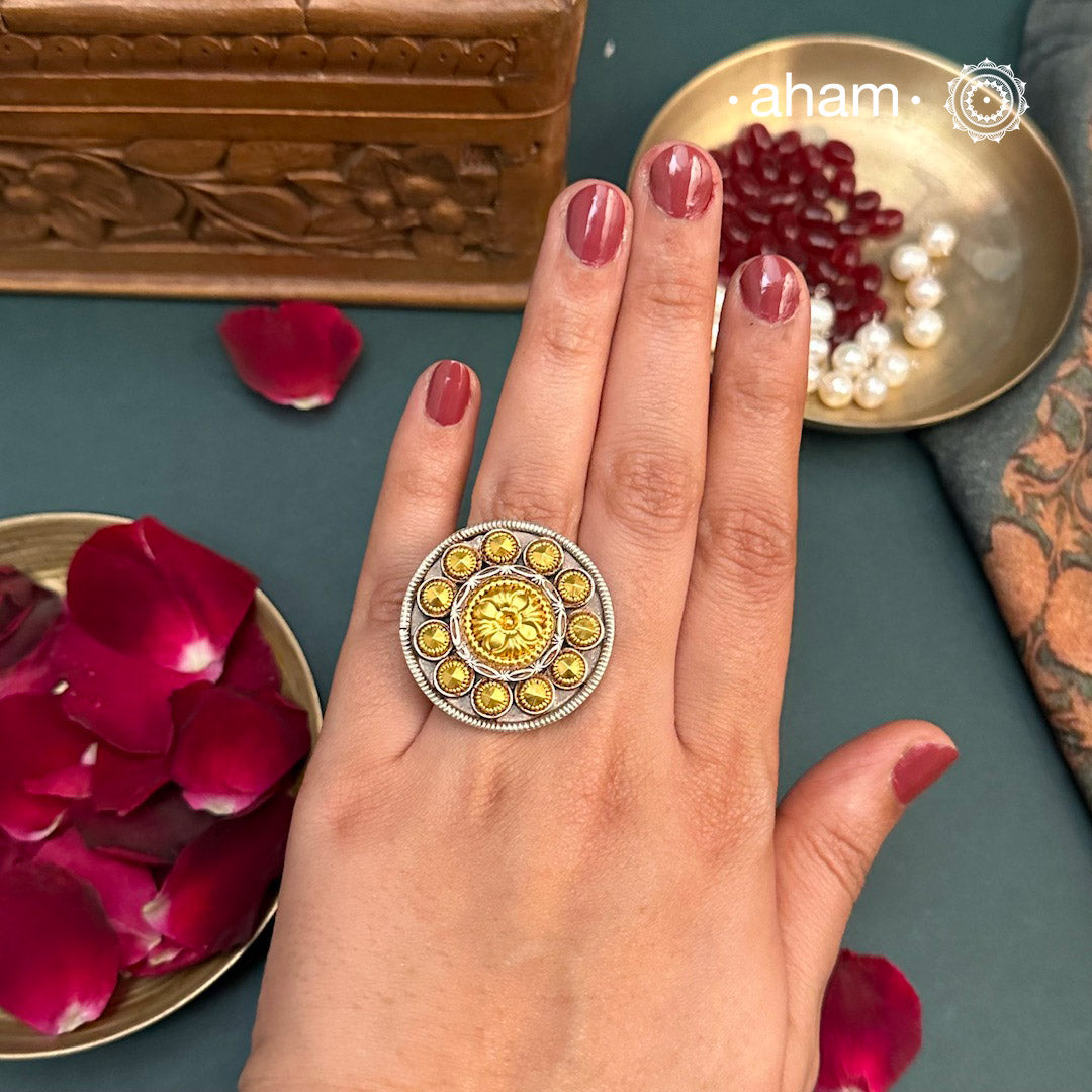 Enhance your style with the timeless elegance of the Two Tone Silver Ring. Handcrafted by skilled karigars in Barmer, Rajasthan, this ring features traditional Bandhel work, where a thin sheet of 22 carat hand beaten gold is set on silver using a unique wax filling technique. A classic representation of Indian craftsmanship.