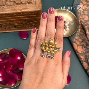 Enhance your style with the timeless elegance of the Two Tone Silver Ring. Handcrafted by skilled karigars in Barmer, Rajasthan, this ring features traditional Bandhel work, where a thin sheet of 22 carat hand beaten gold is set on silver using a unique wax filling technique. A classic representation of Indian craftsmanship.