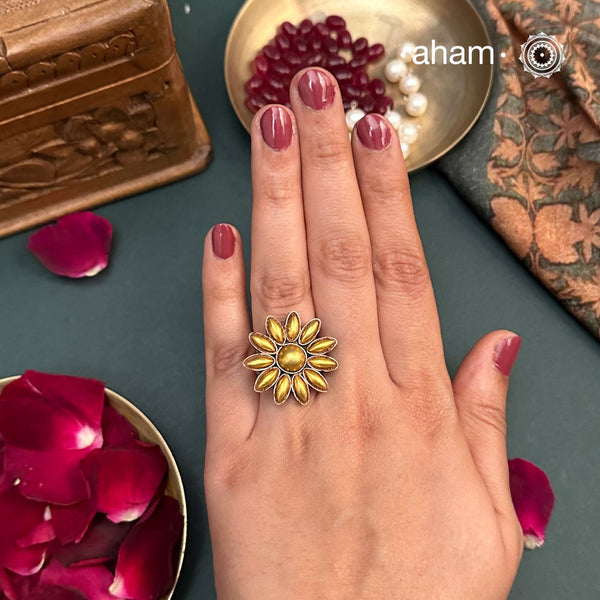 Enhance your style with the timeless elegance of the Two Tone Silver Ring. Handcrafted by skilled karigars in Barmer, Rajasthan, this ring features traditional Bandhel work, where a thin sheet of 22 carat hand beaten gold is set on silver using a unique wax filling technique. A classic representation of Indian craftsmanship.