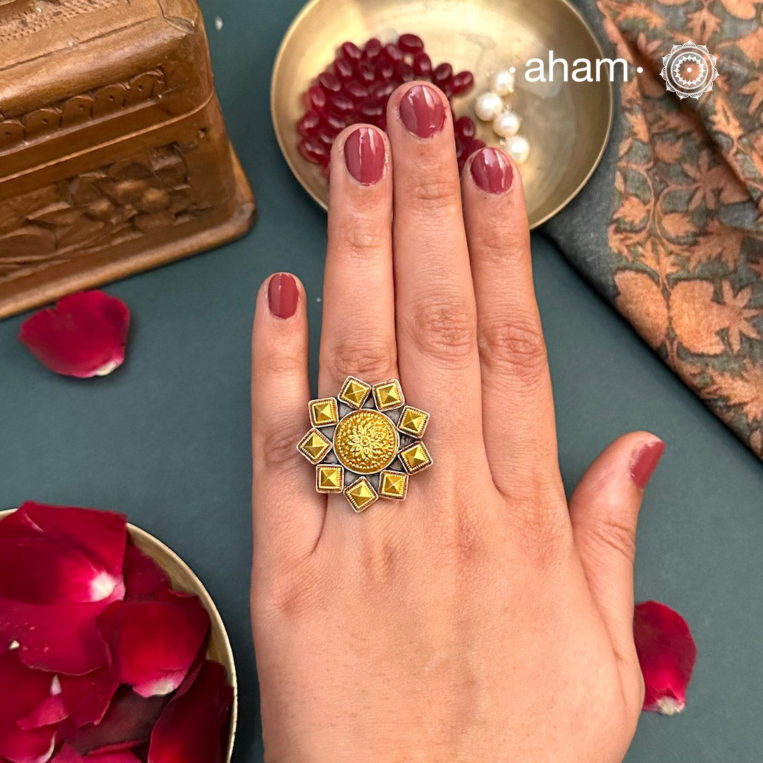 Enhance your style with the timeless elegance of the Two Tone Silver Ring. Handcrafted by skilled karigars in Barmer, Rajasthan, this ring features traditional Bandhel work, where a thin sheet of 22 carat hand beaten gold is set on silver using a unique wax filling technique. A classic representation of Indian craftsmanship.Enhance your style with the timeless elegance of the Two Tone Silver Ring. Handcrafted by skilled karigars in Barmer, Rajasthan, this ring features traditional Bandhel work, where a thin