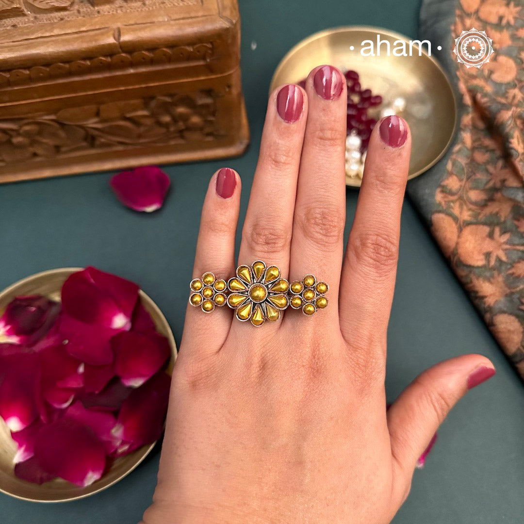 Enhance your style with the timeless elegance of the Two Tone Silver Ring. Handcrafted by skilled karigars in Barmer, Rajasthan, this ring features traditional Bandhel work, where a thin sheet of 22 carat hand beaten gold is set on silver using a unique wax filling technique. A classic representation of Indian craftsmanship.