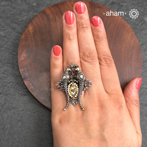 Noori two tone adjustable ring with Parrot motifs. Handcrafted in 92.5 sterling silver with hints of gold polish, pearls and kundan work. Perfect to match your Indian or fusion outfit.