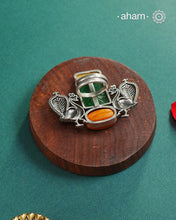 Noori two tone adjustable ring handcrafted&nbsp;in 92.5 sterling silver with hints of gold polish, and green carved stone and coral highlight. Perfect to match your Indian or fusion outfit.