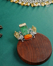 Noori two tone adjustable ring handcrafted&nbsp;in 92.5 sterling silver with hints of gold polish, and green carved stone and coral highlight. Perfect to match your Indian or fusion outfit.&nbsp;