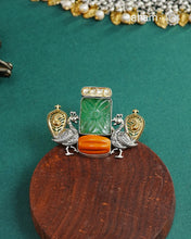 Noori two tone adjustable ring handcrafted&nbsp;in 92.5 sterling silver with hints of gold polish, and green carved stone and coral highlight. Perfect to match your Indian or fusion outfit.