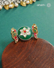 Noori two tone adjustable ring handcrafted in 92.5 sterling silver with green carved stone center and kundan peacocks on either sides. Perfect to match your Indian or fusion outfit. 