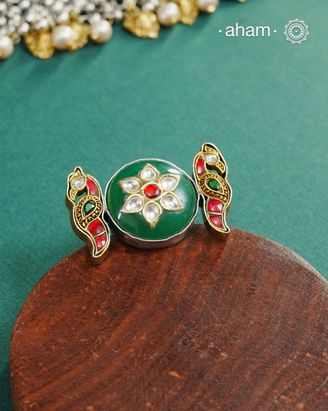 Noori two tone adjustable ring handcrafted in 92.5 sterling silver with green carved stone center and kundan peacocks on either sides. Perfect to match your Indian or fusion outfit. 