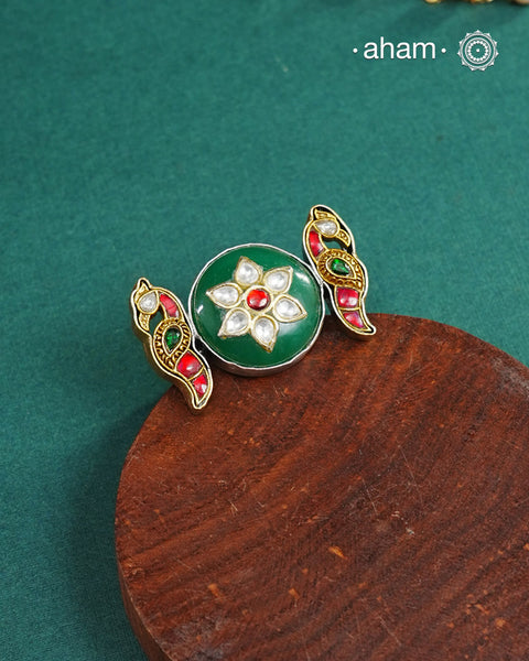 Noori two tone adjustable ring handcrafted in 92.5 sterling silver with green carved stone center and kundan peacocks on either sides. Perfect to match your Indian or fusion outfit. 