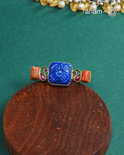 Noori two tone adjustable ring handcrafted in 92.5 sterling silver with carved Lapiz in the center andhints of gold polish and kundan work.  Perfect to match your Indian or fusion outfit. 