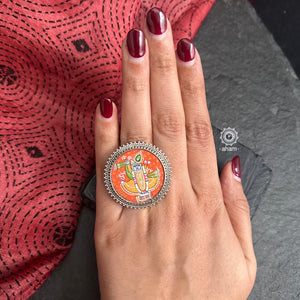 92.5 Sterling silver ring with an intricate hand painted Krishna motif in vibrant colours. Enclosed with a glass top and an adjustable silver ring band, these are one of a kind wearable art pieces. 