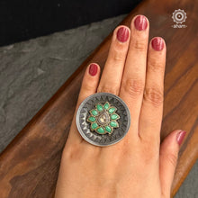 Ira stone set in 92.5 silver with green flower highlight.
Beautiful adjustable ring perfect to add drama to your outfit.